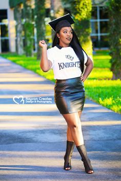 a woman in a black skirt and white t - shirt is posing for the camera