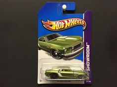 a green hot wheels car is on display