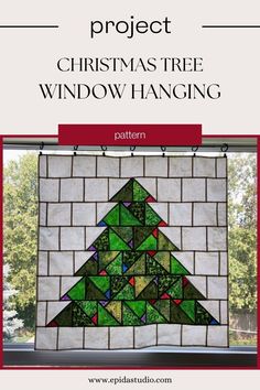 a christmas tree window hanging made out of stained glass and brick with the words project christmas tree window hanging