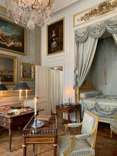 an ornate bedroom with paintings on the walls