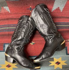 "From Blackbird Vintage of Sedona, Arizona  This is a great pair of black leather Vintage Cowboy Western boots. Marked a Mens size 9. (Should fit a ladies size 10.5 ) Made in USA By \"Dan Post,\" complete with the \"DP\" initials. Condition Notes: -Broken in pre-owned condition with normal signs of wear such as scuffing, soiling, nicks, spots and creasing  -Wear to soles and heels, with plenty of life left -left boot seems to have extra space between the heel and the gold tone adornment. Measure Black Round Toe Boots For Western-themed Events, Vintage Black Boots With Reinforced Heel, Black Boots With Leather Sole For Rodeo, Vintage Black Pointed Toe Boots, Vintage Black Boots For Rodeo, Black Leather Boots For Rodeo, Black Pointed Toe Boots For Western-themed Events, Black Western Boots With Leather Lining, Formal Black Boots With Reinforced Toe