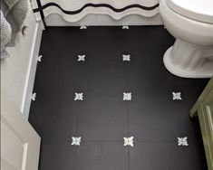 a bathroom with black and white tile flooring