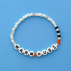 Warm Hugs bracelet! Handmade with love using Czech glass beads, white and black letter beads and stretch cord. Get creative! All my bracelets are meant to be mixed, matched & stacked!  SIZING: Measure your wrist around the widest point and add .25-.5 inches to get the most comfortable or desired fit. If you don't have a flexible tape measure, you can use a piece of string to wrap around your wrist and then measure the length of the string. (For example: my wrist size is 6" and I will wear a 6.5" bracelet for a snug fit and 7" for a loose fit). CARE INSTRUCTIONS: Please be careful to not overstretch bracelets too far. They are made out of a durable elastic string but are still capable of breaking if not handled carefully. Avoid submerging bracelets in water and store in a dry place. I'd lov Disney Friendship Bracelet Ideas, Miranda Core, Disney Bands, Cute Friendship Bracelets, Homemade Bracelets