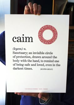 a person holding up a sign with the words calm on it in front of their face