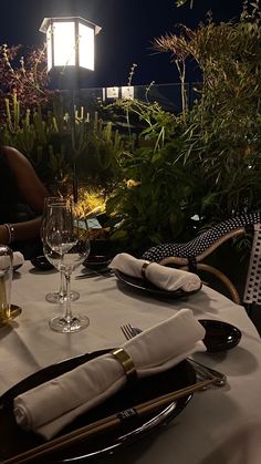 the table is set for dinner outside at night