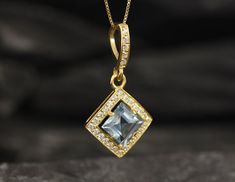 Gold Blue Topaz Pendant set with Natural Blue Topaz in a princess diamond cut, flawless clarity & yellow color, at 8x8mm, 3 Carats.Square Pendant design made of Gold Vermeil ☞ thickest 18k Gold Plating on top of Solid 925 Sterling Silver ☞ made to last.Free Gold Vermeil Chain with every Pendant order, 18 inch Silver chain (46 cm) ✓Matching Ring: www.etsy.com/uk/listing/868103249Matching Earrings: www.etsy.com/uk/listing/1047753659December Birthstone - Genuine & Natural Stones ❀⌛ Last Pen Sapphire Jewelry With Single Cut Diamonds For Gift, Sapphire Jewelry With Single Cut Diamonds As A Gift, Aquamarine Jewelry With Diamond Accents For Gift, Gift Jewelry With Diamond Accents And Aquamarine, Gift Aquamarine Jewelry With Diamond Accents, Fine Jewelry With Princess Cut Blue Topaz, Sapphire Jewelry With Princess Cut For Gift, Wedding Necklace With Blue Topaz Accent Stones, Blue Princess Cut Jewelry With Diamond Accents