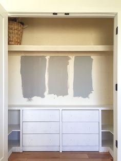 an empty closet with paint samples on the shelves