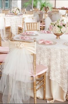 the tables are decorated with pink and white linens