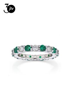 a white gold ring with emerald stones and diamonds on the inside, set in 18k white gold