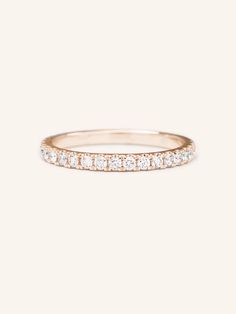 a rose gold band with white diamonds on top and bottom, set in 18k yellow gold