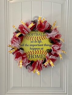 a baseball wreath is hanging on the door to say softball as in life, all the important things happen at home