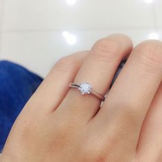 a woman's hand with a diamond ring on it