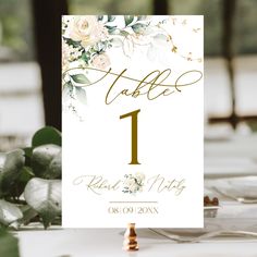 a table number sign sitting on top of a white table