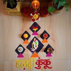 a decorated diya with candles and flowers on the floor