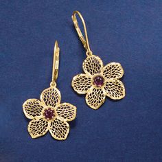 Ross-Simons - Italian .90 ct. t. w. Garnet Flower Drop Earrings in 14kt Yellow Gold. Embrace the natural beauty of spring by adding these flourishing flowers to your look all year long. Crafted in Italy, the elegant openwork flowers are dazzled with .90 ct. t. w. garnet centers. Diamond-cut, textured and polished 14kt yellow gold. Hanging length is 1 3/8". Leverback, garnet flower drop earrings. Garnet birthstones are the perfect gift for January birthdays. Formal Flower-shaped Clip-on Jewelry, Formal Pierced Flower-shaped Jewelry, Formal Pierced Flower Shaped Jewelry, Formal Flower-shaped Pierced Jewelry, Pierced Flower-shaped Earrings For Formal Occasions, Pierced Flower Shaped Earrings For Formal Occasions, Elegant Flower Earrings With Lever Back For Anniversary, Formal Flower Shaped Clip-on Jewelry, Elegant Yellow Gold Clip-on Flower Earrings