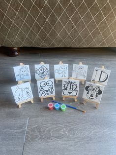 a group of small paintings sitting on top of a wooden floor