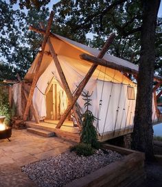 a tent is lit up in the evening