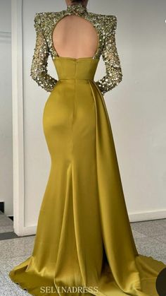 the back of a woman's dress in gold with sequins on it