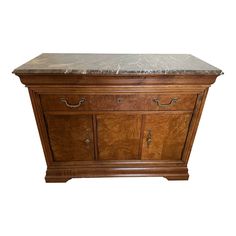 a wooden cabinet with marble top and drawers on the bottom shelf, against a white background