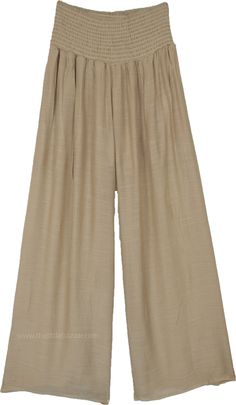 These elegant wide-leg pants come in a sophisticated beige shade, crafted from a lightweight and breathable fabric perfect for warm weather.  The pants feature a smocked waistband, ensuring a comfortable and secure fit that adapts to various body types. #tlb #SplitSkirtsPants #vacationclothing #BeigePants Cream Wide Leg Pants With Elastic Waistband For Spring, Beige Wide Leg Pants With Elastic Waistband, Elegant Beige Wide Leg Pants With Elastic Waistband, Beige Wide Leg Full Length Pants For Spring, Baggy Beige Bohemian Bottoms, Chic Summer Khaki Wide Leg Pants, Chic Khaki Wide Leg Pants With Elastic Waistband, Elegant Beige Wide Leg Pants For Summer, Elegant Khaki Pants For Summer