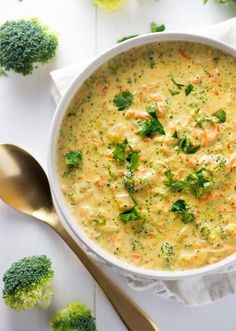 a white bowl filled with broccoli and cheese