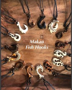 the words makau fish hooks are arranged in a circle on a wooden surface