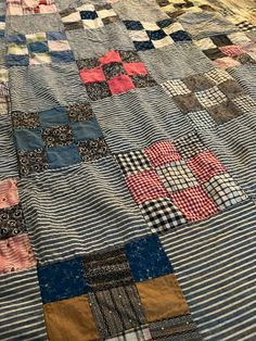 an old quilt is laying on the floor with it's edges cut off and stitched together