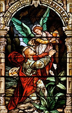 a stained glass window with an angel holding a child