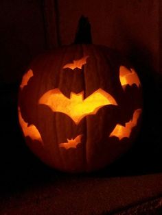 a carved pumpkin with bats on it