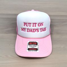 PUT IT ON MY DAD'S TAB embroidered on your favorite color Otto Foam High-Profile Trucker Hat. How to Order: 1. Choose the color hat  2. Pick the thread color  The saying can be customized. Message us before ordering with your request or any questions. Hat Description:  The Traditional Look 5-panel cap Seamless Foam Front Panel with Lining Matching Color Braid Visor Matching Fabric Undervisor, Adjustable Snapback SHAPE: High-Profile FABRIC:  100% Polyester Front,  Mesh Back VISOR: Pre-curved FIT Funny Letter Print Hats For Gift, Funny Letter Print Hat As Gift, Funny Letter Print Hats As Gifts, Funny Hats With Letter Print As Gift, Pink Hats With Curved Bill For Gift, Funny White Hat As A Gift, Funny White Hat As Gift, Pink Curved Bill Hat As Gift, White Letter Print Hat As Gift