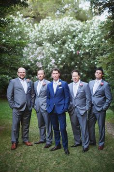 a group of men in suits standing next to each other