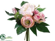 a vase filled with pink and white flowers on top of a green leafy plant