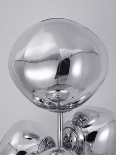 a chrome sculpture is shown against a white background