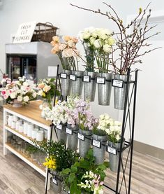 a flower shop with lots of flowers on display