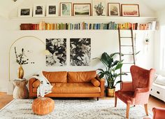 a living room filled with furniture and lots of pictures on the wall above it's bookshelf