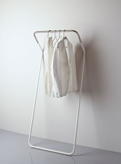 an ironing board with clothes hanging on it