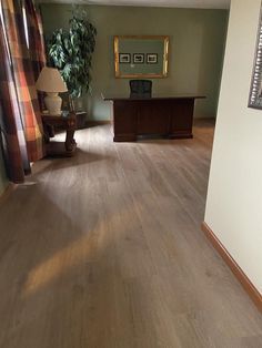 a living room with hard wood floors and green walls