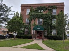 an apartment building with ivy growing all over it