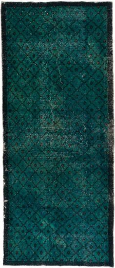 a blue rug with an intricate design on the top and bottom, it is very dark green