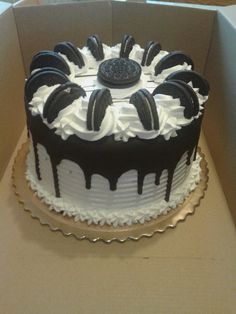 a cake in a box with white and black icing