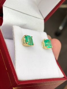 Featured here is a beautiful set of emerald cut Colombian emerald studs in fine 14K yellow gold. Displayed are medium-green emeralds with very good transparency, accented by a simple four-prong 14K gold mount, allowing for the emerald to be shown in full view. The earth mined, green Colombian emeralds have a desirable lush green color with excellent qualities. These earrings are ideal for everyday use and are the perfect accessory to any outfit. Total Carat Weight: 2.0cts Setting Style: Four Pro Green Baguette Cut Earrings For Gifts, Emerald Cut Green Gemstone Earrings, Fine Jewelry Emerald Cut May Birthstone Earrings, Fine Jewelry Baguette Cut Emerald Earrings, Fine Jewelry Emerald Cut Earrings For May Birthstone, Baguette Cut Emerald Earrings As A Gift, May Birthstone Emerald Cut Fine Jewelry Earrings, Emerald Cut Green Earrings, Emerald Cut Emerald Earrings In Yellow Gold