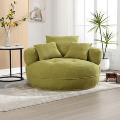 a living room with a large round chair and potted plant on the side table