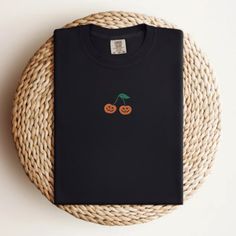 If you love Halloween & nostalgia - you NEED this Embroidered Pumpkin Cherry Comfort Colors T-Shirt! This is perfect for the fall season- would also make a great gift for someone that is obsessed with all things Halloween/Fall. * PRODUCT DETAILS * ✺ 100% Cotton ✺ Wash and dry normally (on cool for best results) ✺ Due to different monitor screens, colors may vary ✺ * SIZING * ✺ FOR AN OVERSIZED FIT, SELECT TWO OR THREE SIZES UP FROM YOUR NORMAL SIZE ✺ ✺ Sizing is unisex ✺ Size guide: Please consu Black Embroidered Tops For Halloween, Embroidered Cotton Tops For Halloween, Halloween Streetwear Embroidered Top, Embroidered Black T-shirt For Fall, Black T-shirt With Custom Embroidery For Fall, Black Embroidered T-shirt For Fall, Halloween Embroidered Streetwear Top, Halloween Embroidered Cotton Tops, Halloween Cotton Embroidered Tops