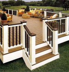 an outdoor deck with chairs and couches on it