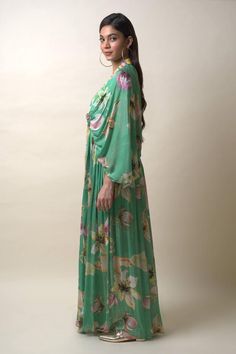 Green chiffon kaftan dress with floral print and sequins hand embroidered placket and neckline. Comes with an inner.
Components: 2
Pattern: Printed, Hand embroidered
Type Of Work: Floral, Sequins
Neckline: V Neck
Sleeve Type: Flared Sleeves
Fabric: Chiffon
Color: Green
Other Details: 
Length : Dress - 57 inches
Occasion: Party - Aza Fashions Green Floral Print Maxi Kaftan, Floor-length Georgette Kaftan For Spring, Bohemian Floral Print Evening Kaftan, Spring Green Long Kaftan Dress, Green Silk Chiffon Dress For Spring, Elegant Chiffon Kaftan For Spring, Spring Green Floral Print Kaftan, Green Dress With Floral Print And Kimono Sleeves, Green Maxi Dress With Floral Print And Kimono Sleeves