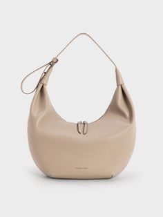 This product is made with at least 20% sustainable materials by weight. CHARLES & KEITH uses recycled, degradable, organic, and water-based materials in our eco-conscious collection. For the minimalist girls, the Odella hobo bag is the perfect everyday carrier. Its sleek crescent shape lets clean curves and the polished taupe finish stand out, making it a stylish accessory that is as chic as it is versatile. For a relaxed feel, tasteful ruching gives the carrier a slouchy look that will pair well with off-duty ensembles. Complete with a roomy interior, you will want to reach for the Odella over and over again. Crescent Shape, Size Chart For Kids, Vegan Leather Bag, Consumer Protection, Charles Keith, Printables Kids, Everyday Bag, Sustainable Materials, Online Bags