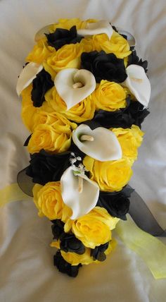 a bridal bouquet with yellow roses and calla lilies