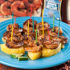 some food is on a blue plate with toothpicks