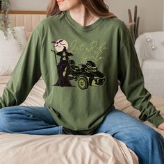 Get spooky this season with our Can-Am Spyder Halloween-themed cozy long sleeve crew neck T-shirt! Featuring the bold "Let's Ride Girls" text, this shirt showcases a witch holding a staff, a haunting moon with bats, and a detailed Can-Am Spyder motorcycle graphic in classic Halloween colors of purple, black, and green. Perfect for female riders who love the Halloween vibe, this T-shirt is a must-have for your fall wardrobe or Halloween events. Comfortable and stylish, it's the ideal gift for Can-Am enthusiasts ready to ride into the spooky season! This classic unisex jersey short sleeve tee fits like a well-loved favorite. Product Details Made with 100% ring-spun cotton, these personalized long-sleeve shirts come packed with softness and style. Each tee features garment-dyed fabric and com Moon With Bats, Spooky Moon, Bike Rally, Halloween Colors, Can Am Spyder, Halloween Long Sleeve, Girls Halloween, Crew Neck Tshirt, Bike Week