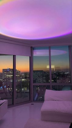 a living room with large windows and a rainbow colored ceiling in the middle of it